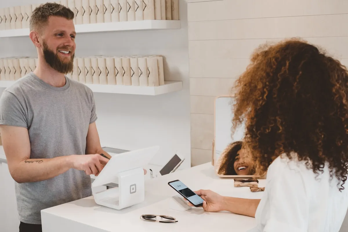 Digital punch card on a smartphone next to a paper loyalty card